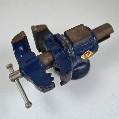 Old blue vise with a red and yellow logo on a white background