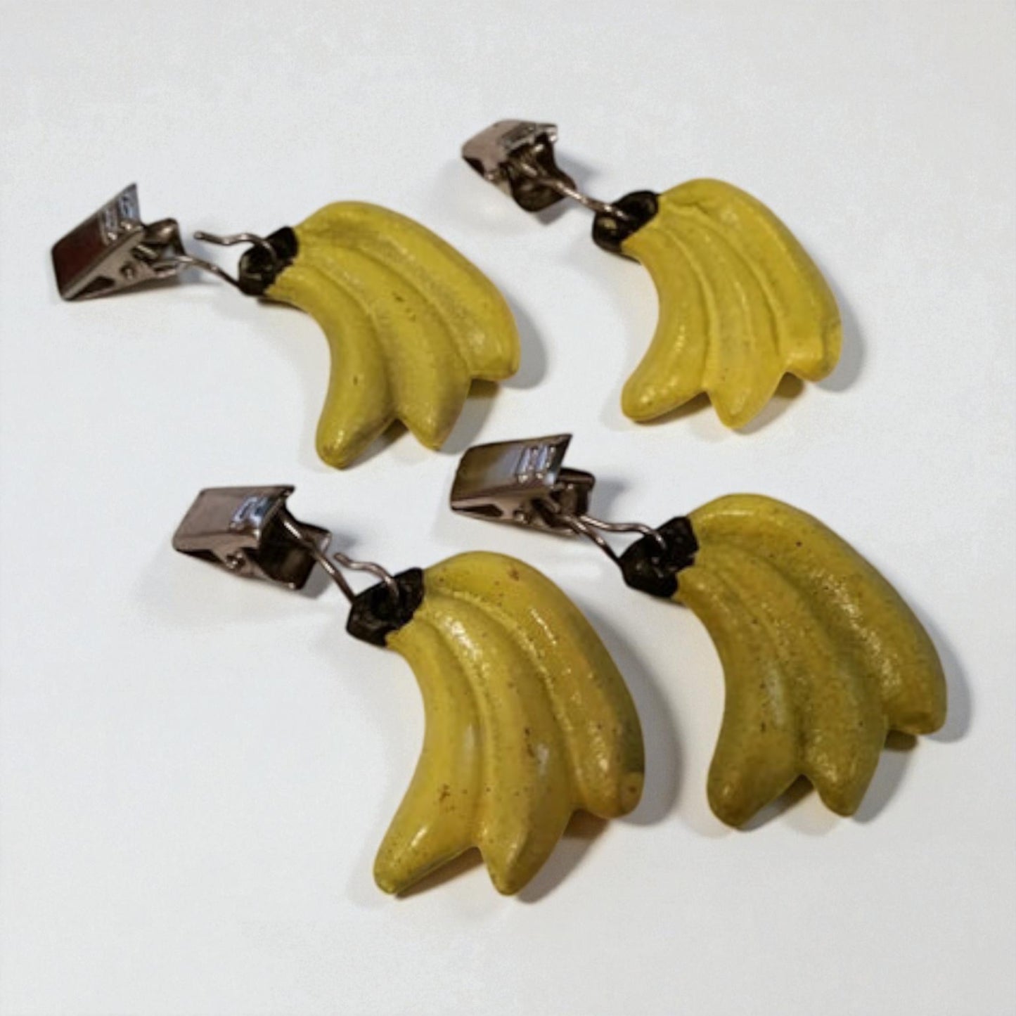 Banana-shaped earrings on a white background