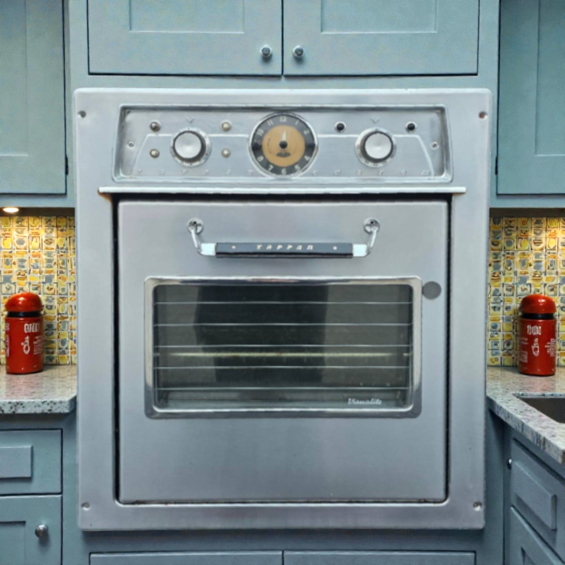 Vintage-style oven in a kitchen with tiled backsplash and cabinets.