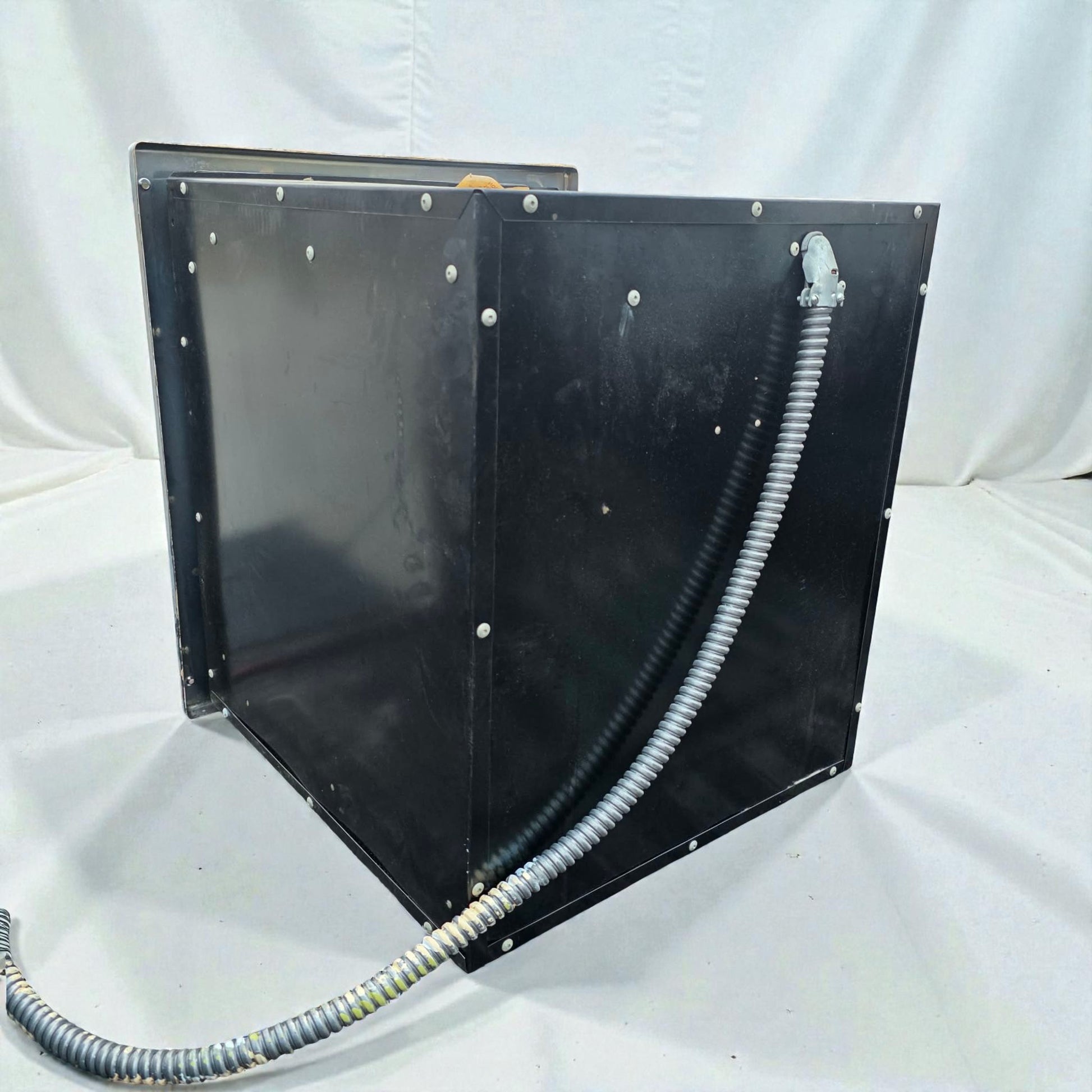 Black metal enclosure with a hose on a white background