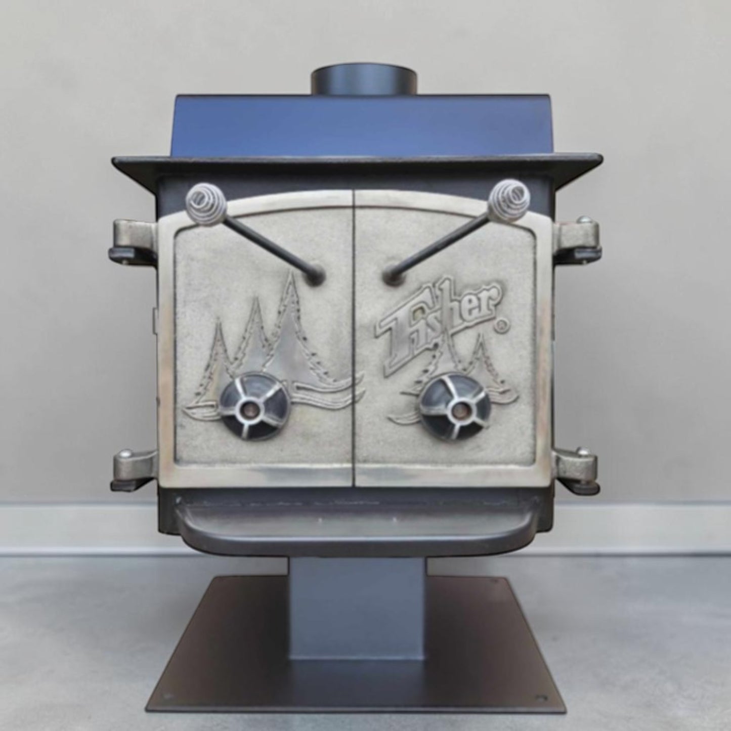 Vintage Fisher Teddy Bear wood stove with full factory nickel doors and pedestal base.
