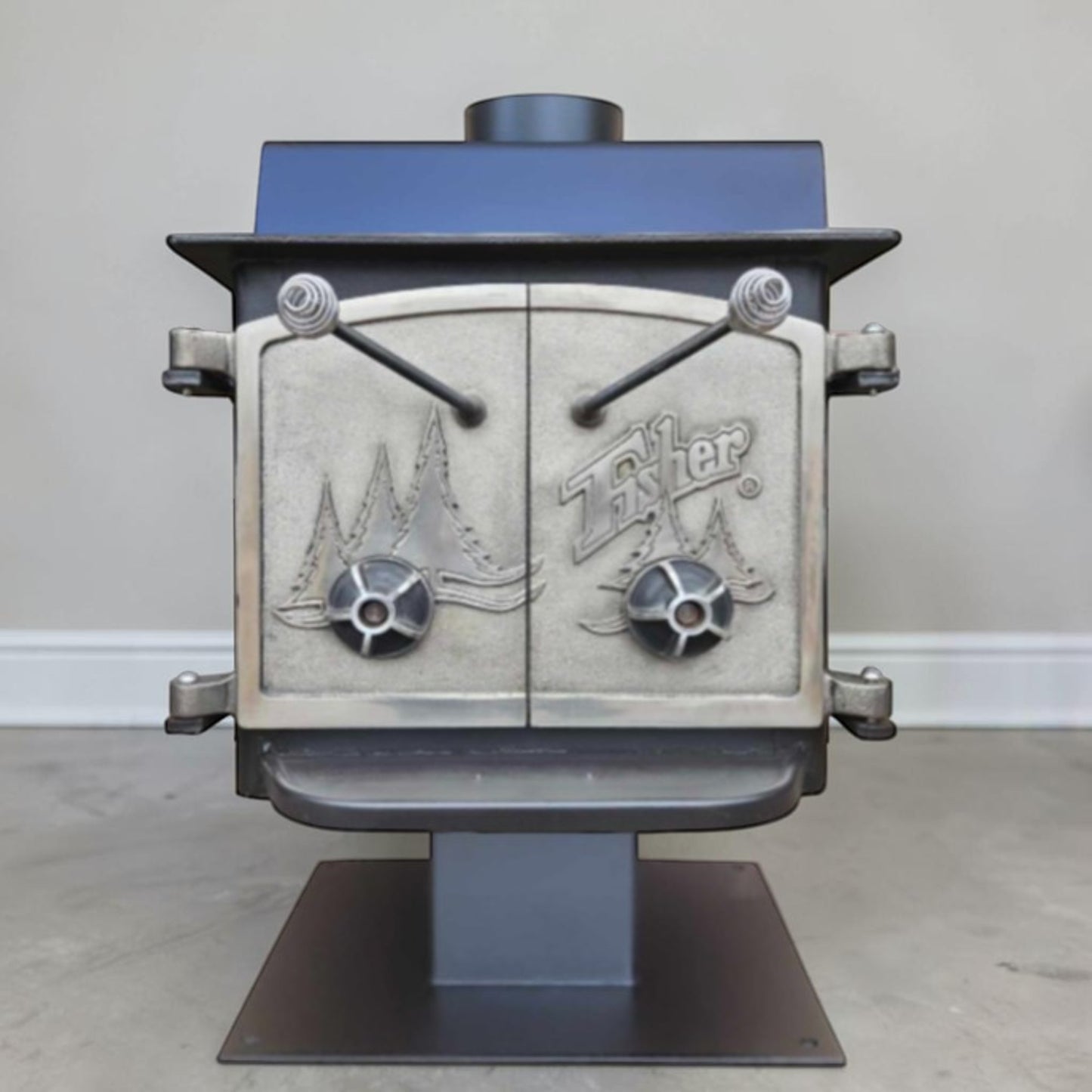 Vintage Fisher Teddy Bear wood stove with full factory nickel doors and pedestal base.
