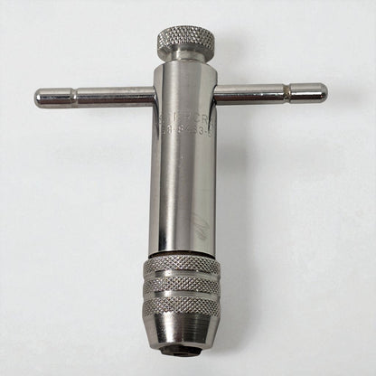 Metal t-wrench on a white background