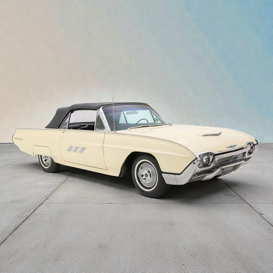 Vintage convertible car on a concrete surface with a neutral background