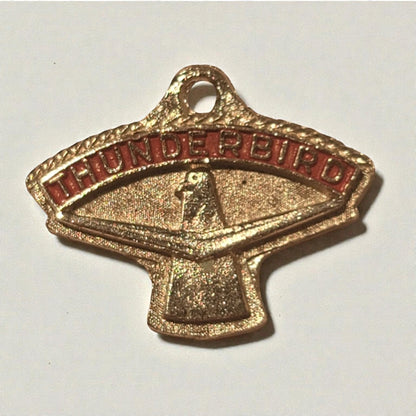 Gold and red 'Thunderbird' emblem on a white background