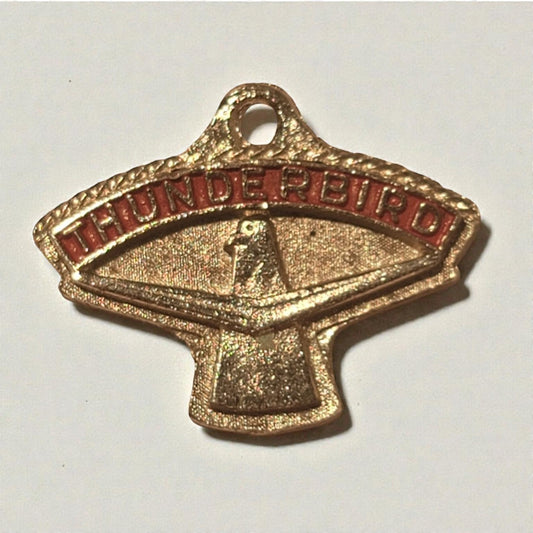 Gold and red 'Thunderbird' emblem on a white background