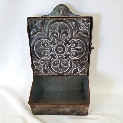 Decorative metal wall shelf with intricate patterns on a white background