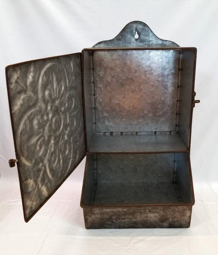 Decorative metal box with embossed design on a white background