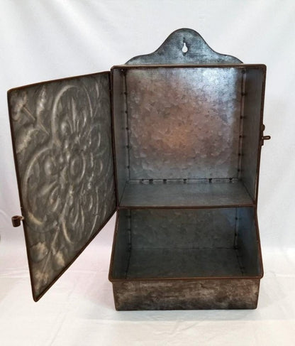 Decorative metal box with embossed design on a white background