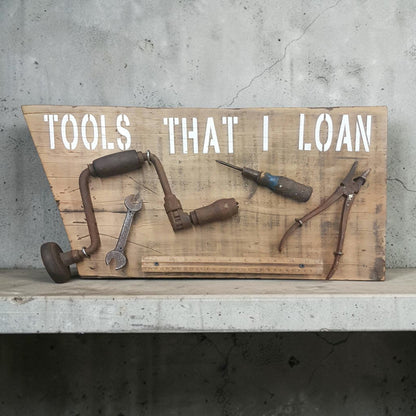 Handmade rustic Tools That I Loan garage sign with five useless tools
