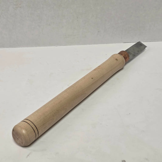 Custom-made thin woodturning parting chisel for precision detail work on a wood lathe.