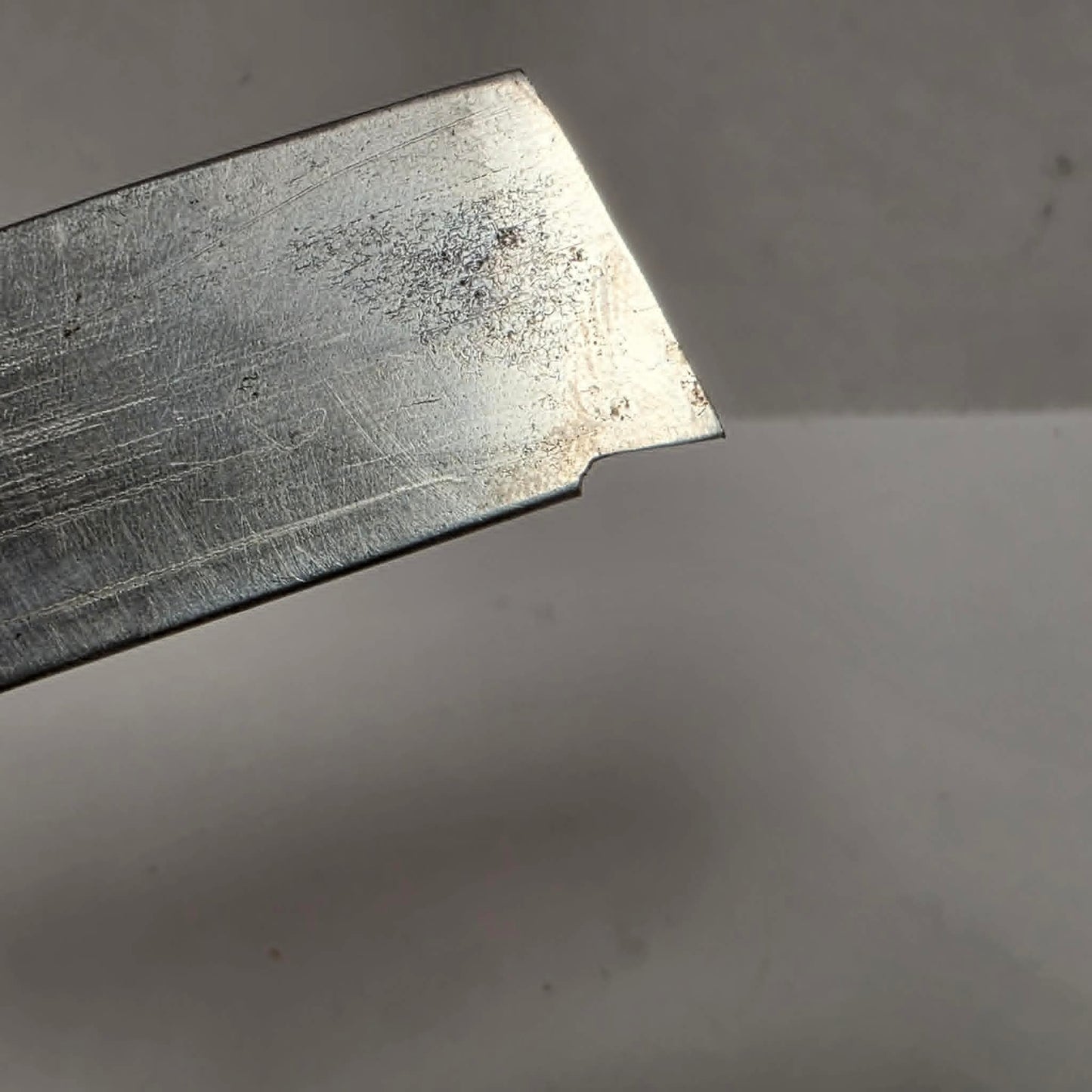 Custom-made thin woodturning parting chisel for precision detail work on a wood lathe.