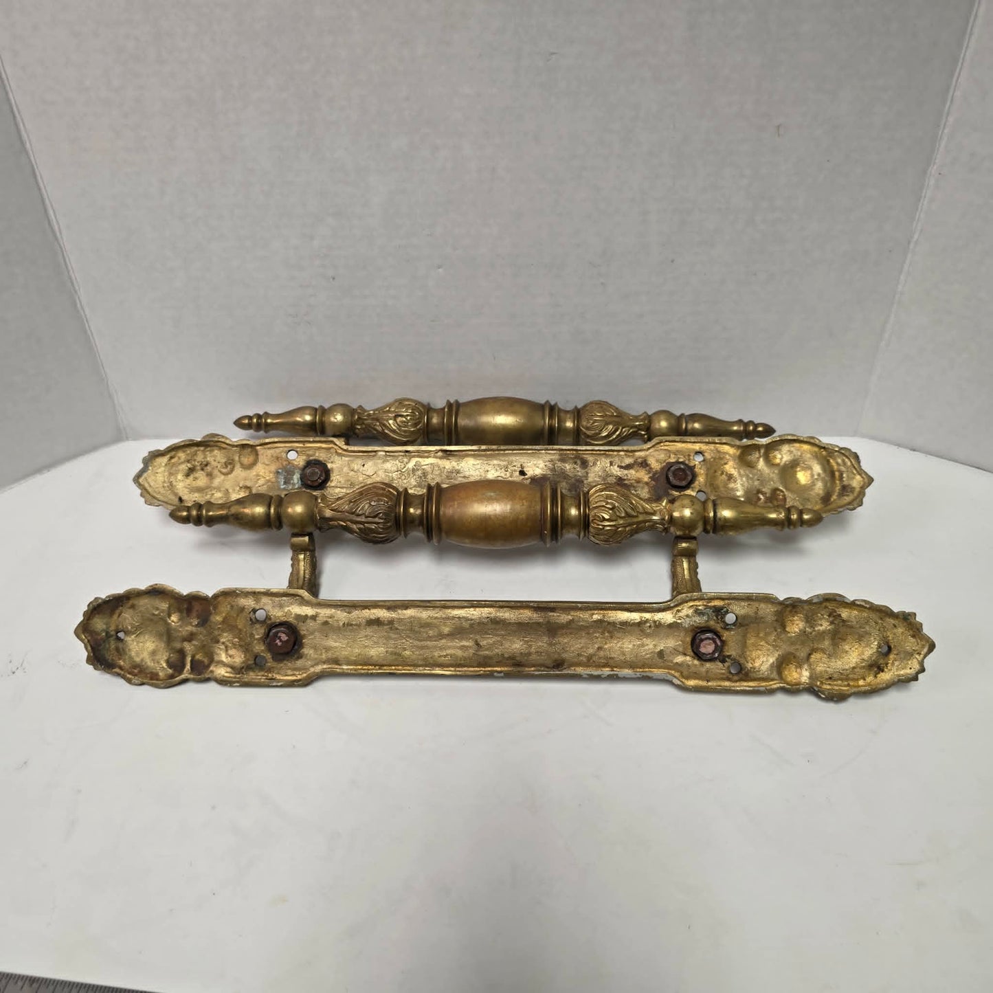 Pair of large Victorian brass bronze hotel door handles with butterfly design, crosshatched plates, and shell details. Antique architectural salvage hardware.