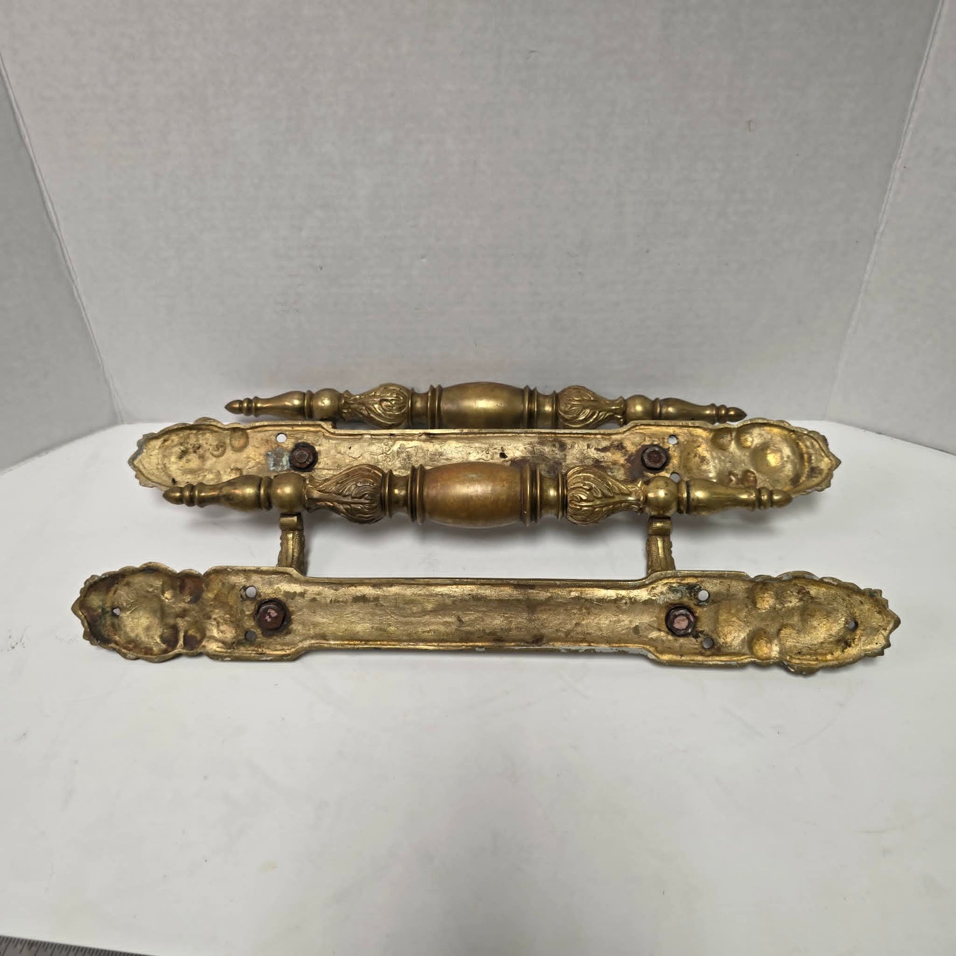 Pair of large Victorian brass bronze hotel door handles with butterfly design, crosshatched plates, and shell details. Antique architectural salvage hardware.