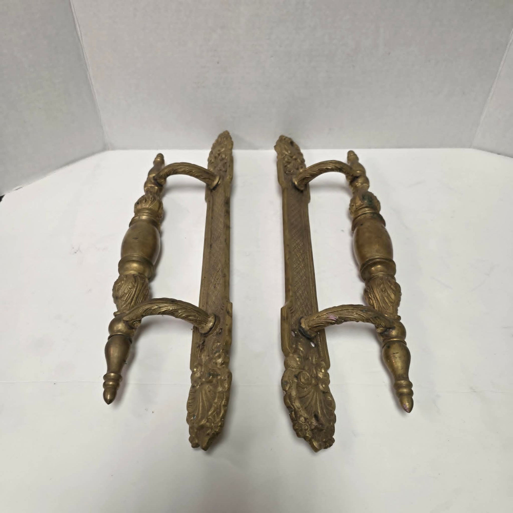 Pair of large Victorian brass bronze hotel door handles with butterfly design, crosshatched plates, and shell details. Antique architectural salvage hardware.
