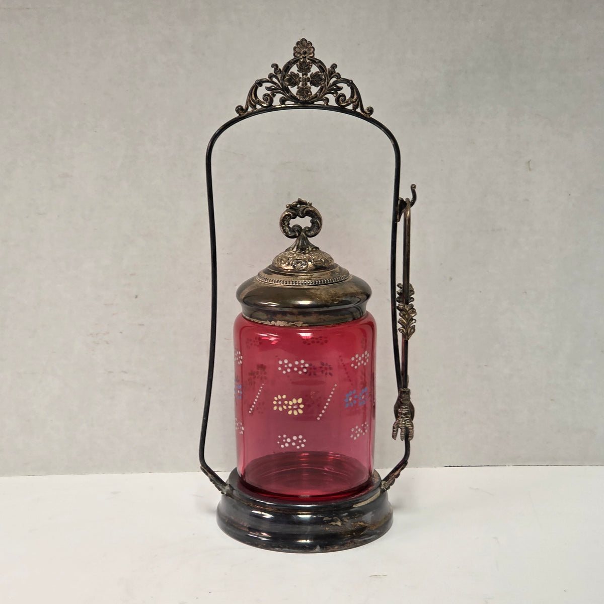 Victorian cranberry glass cruet with bird claw tongs
