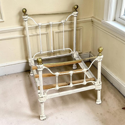 A charming Victorian iron and brass miniature bed from a bygone era.