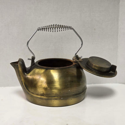 Vintage brass plated cast iron kettle with attached swivel lid for wood stove use.
