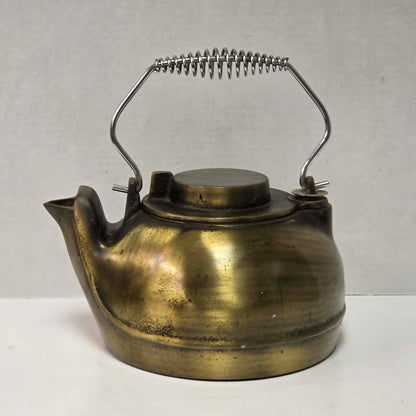 Vintage brass plated cast iron kettle with attached swivel lid for wood stove use.
