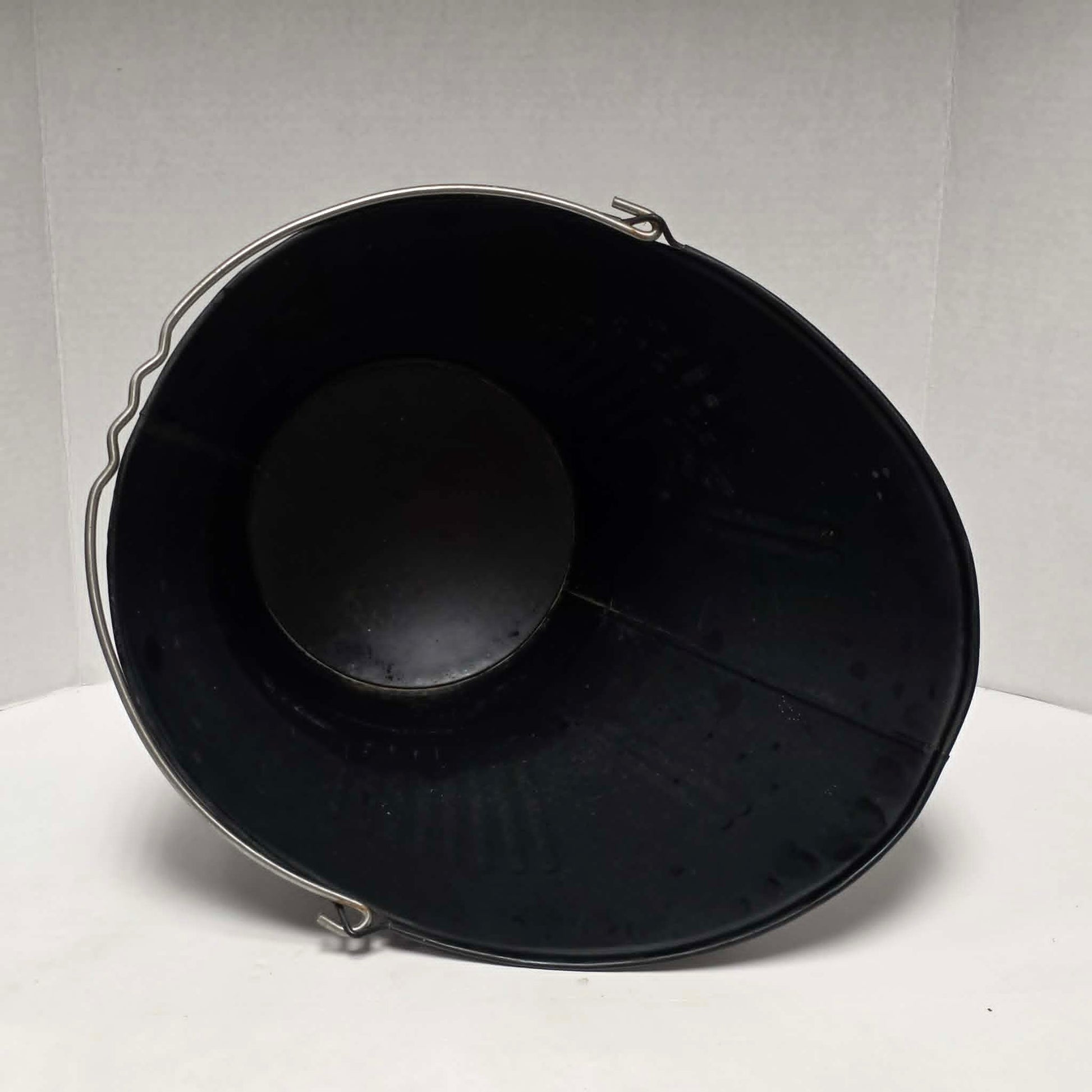 Vintage metal coal scuttle with bail handle for fireplace and wood stove use.
