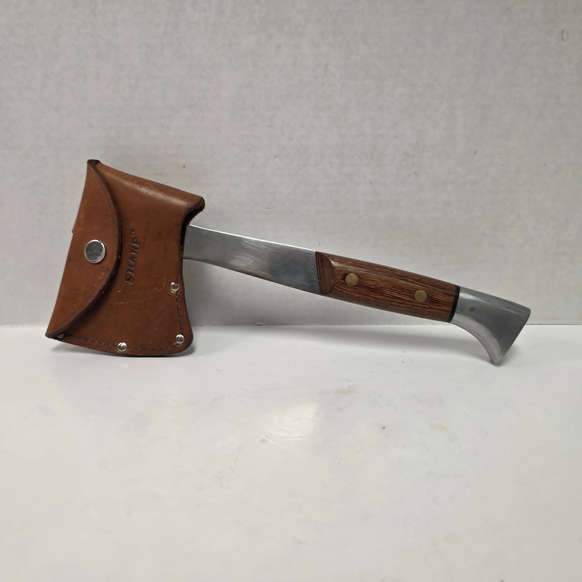 A beautifully crafted vintage camping axe featuring a rosewood handle, sharp stainless steel blade, and quality leather sheath.
