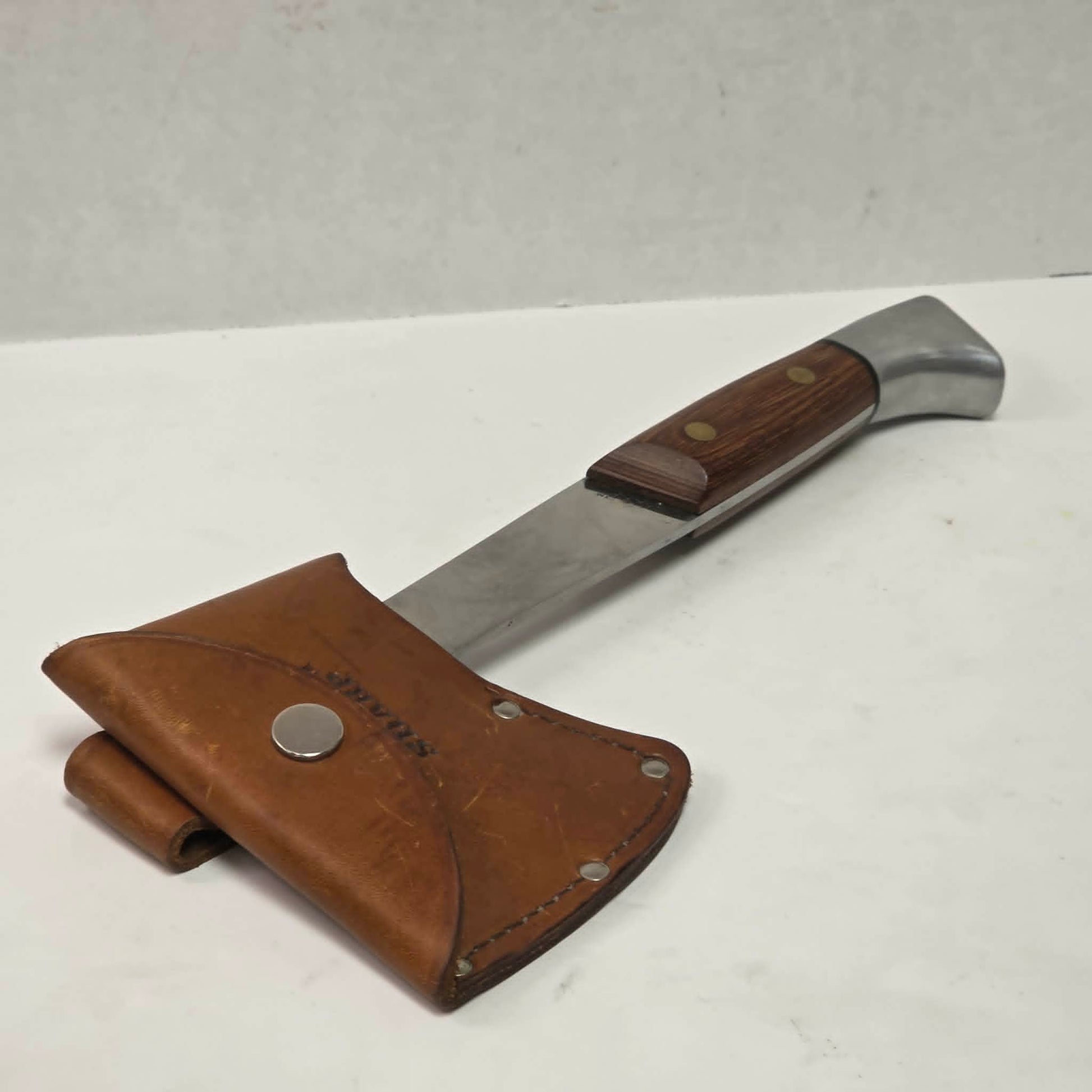 A beautifully crafted vintage camping axe featuring a rosewood handle, sharp stainless steel blade, and quality leather sheath.
