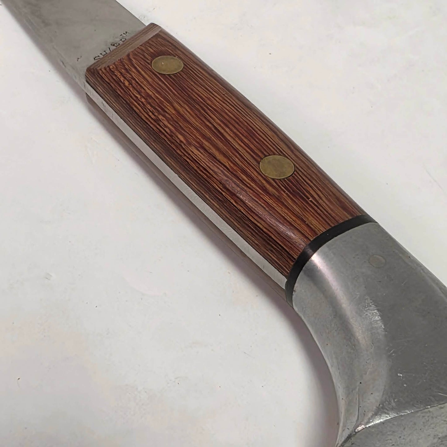 A beautifully crafted vintage camping axe featuring a rosewood handle, sharp stainless steel blade, and quality leather sheath.
