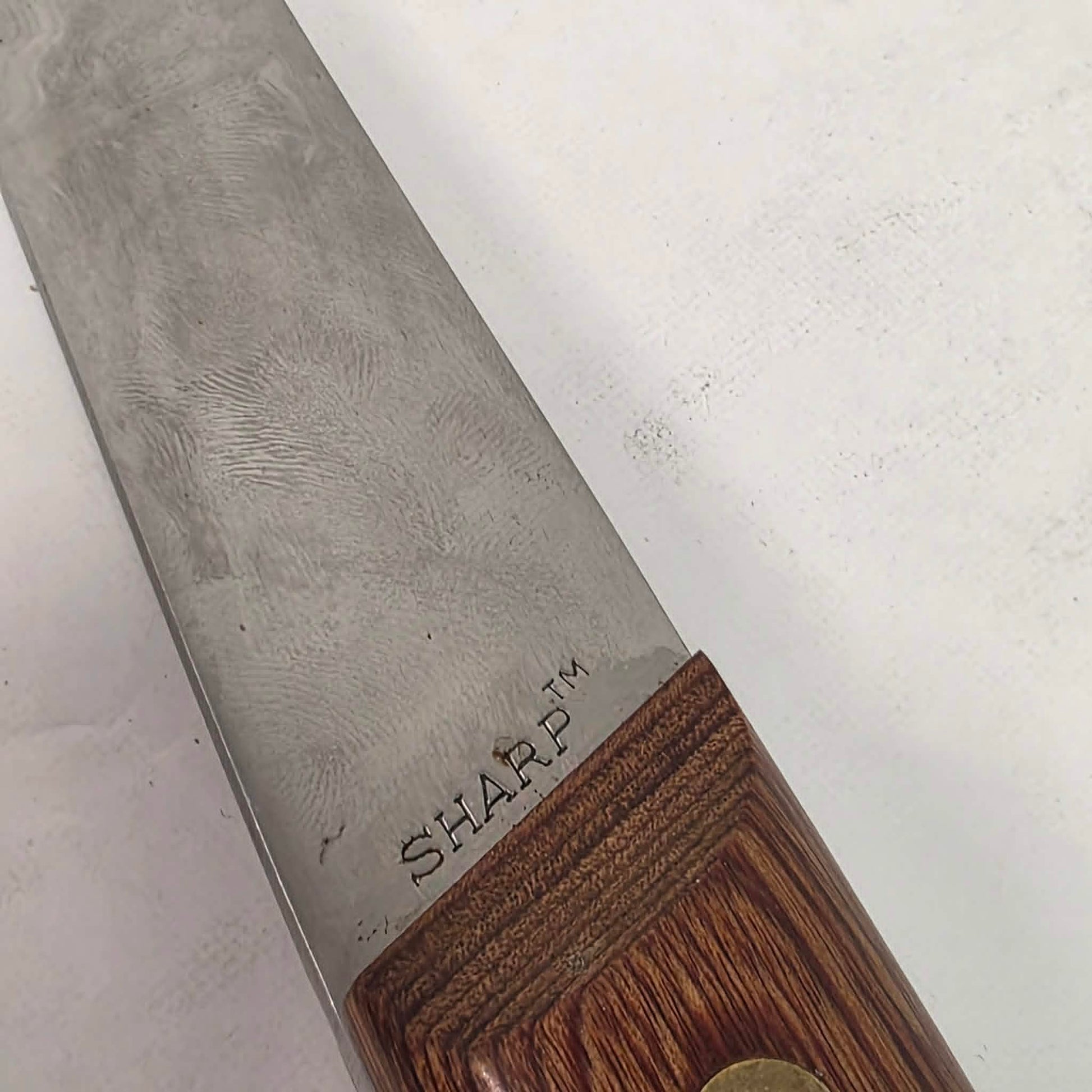A beautifully crafted vintage camping axe featuring a rosewood handle, sharp stainless steel blade, and quality leather sheath.
