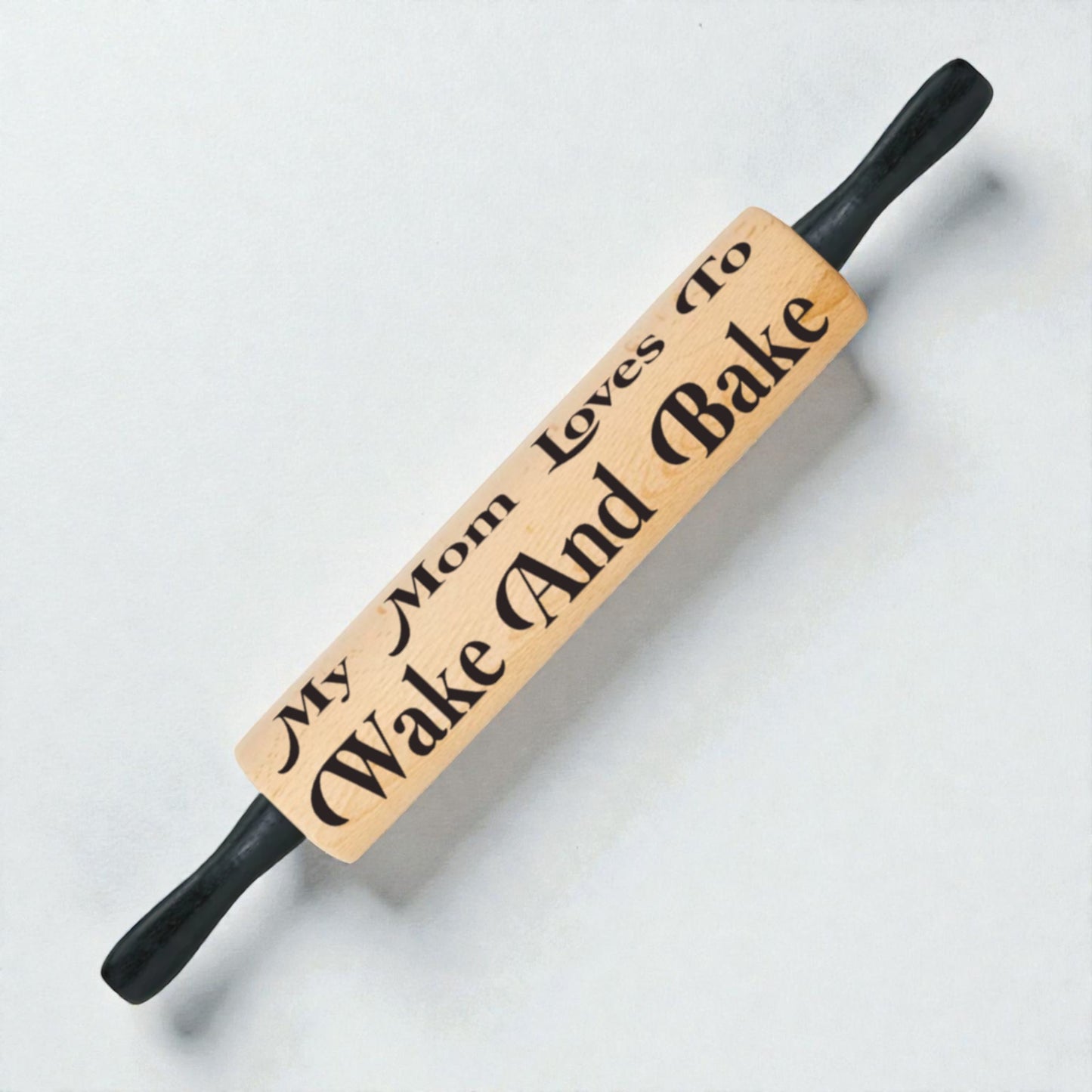 Wooden rolling pin with engraved text on a light background