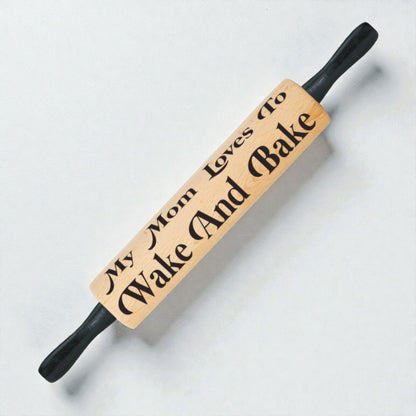 Wooden rolling pin with engraved text on a light background