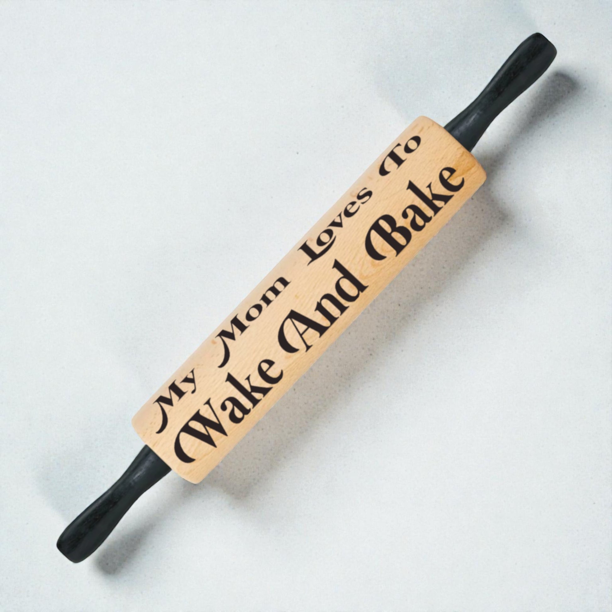 Wooden rolling pin with engraved text on a light background
