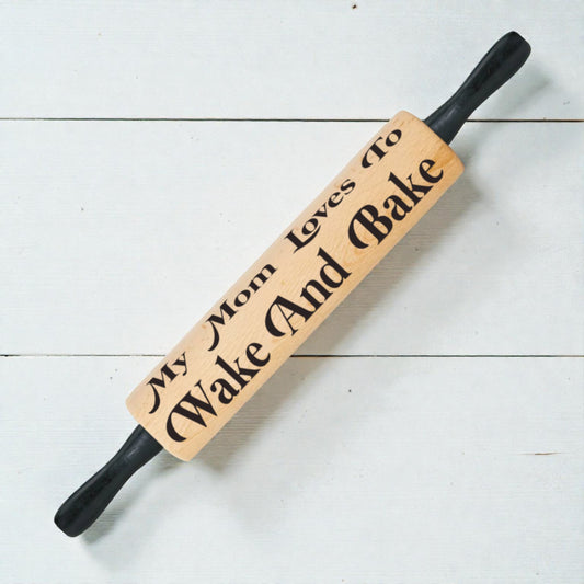 Wooden rolling pin with engraved text on a white wooden surface