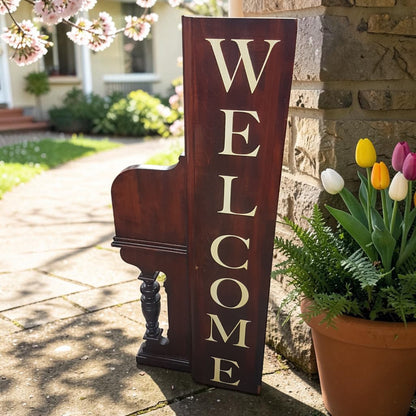 Unique welcome sign created from an authentic century-old piano, perfect for music lovers and rustic spaces.