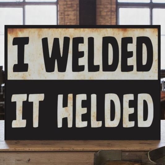 Garage wall art featuring the phrase 'I welded, it helded' on an aluminum sign