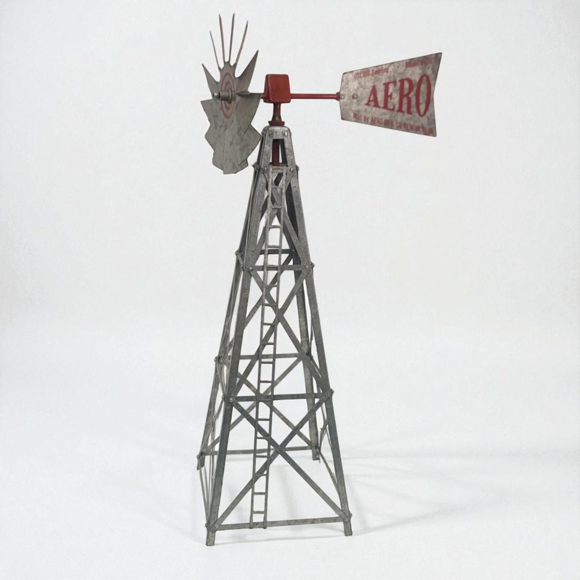 Model windmill with 'Aero' sign on a white background