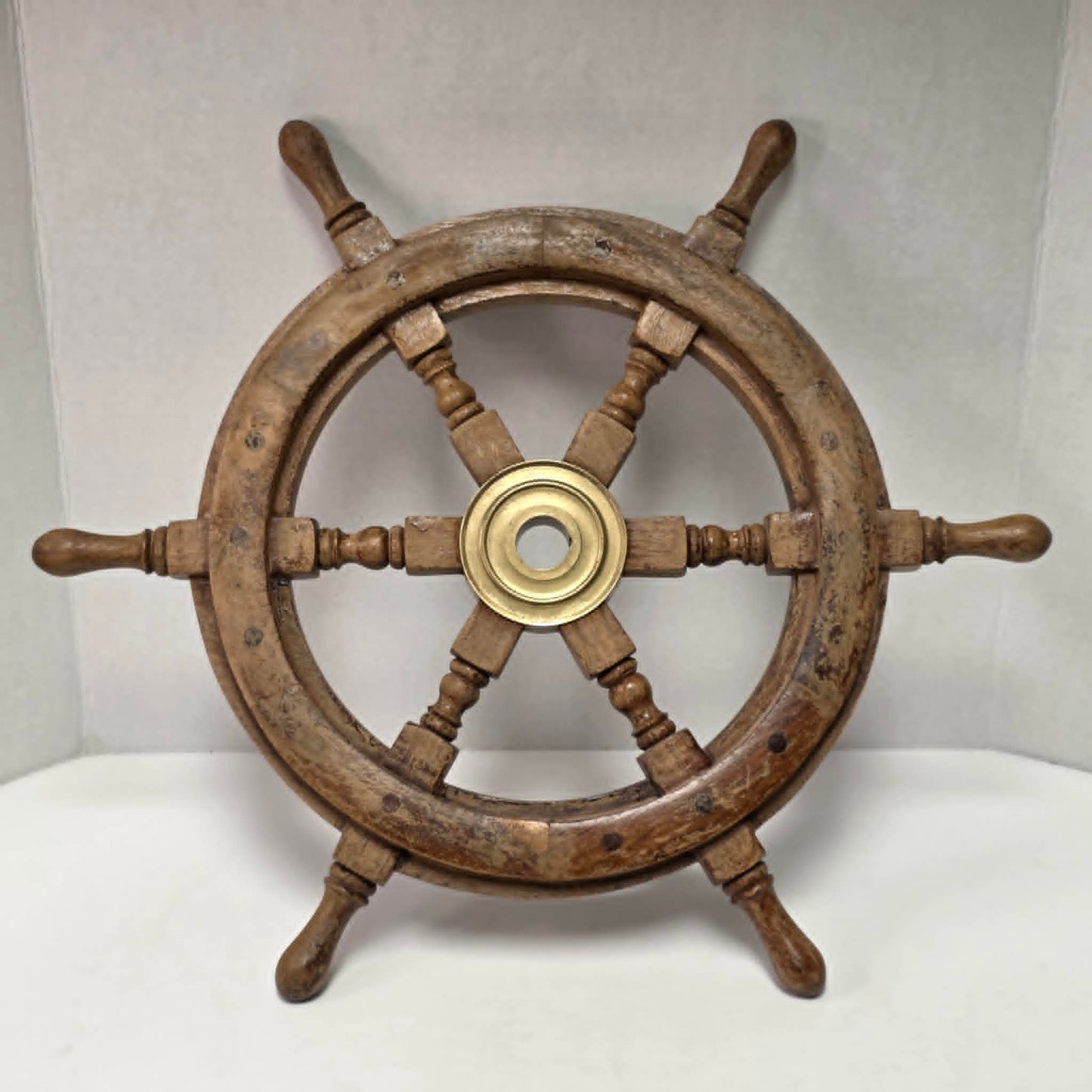 Authentic vintage wood and brass ship's wheel with beautiful original maritime patina.