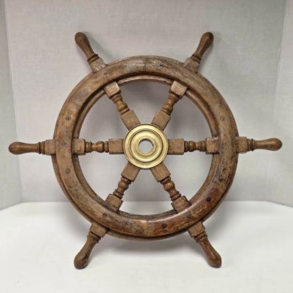 Authentic vintage wood and brass ship's wheel with beautiful original maritime patina.