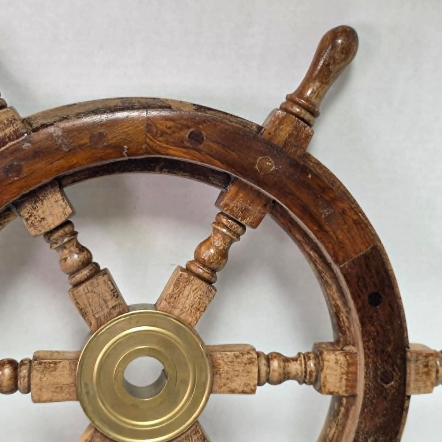 Authentic vintage wood and brass ship's wheel with beautiful original maritime patina.