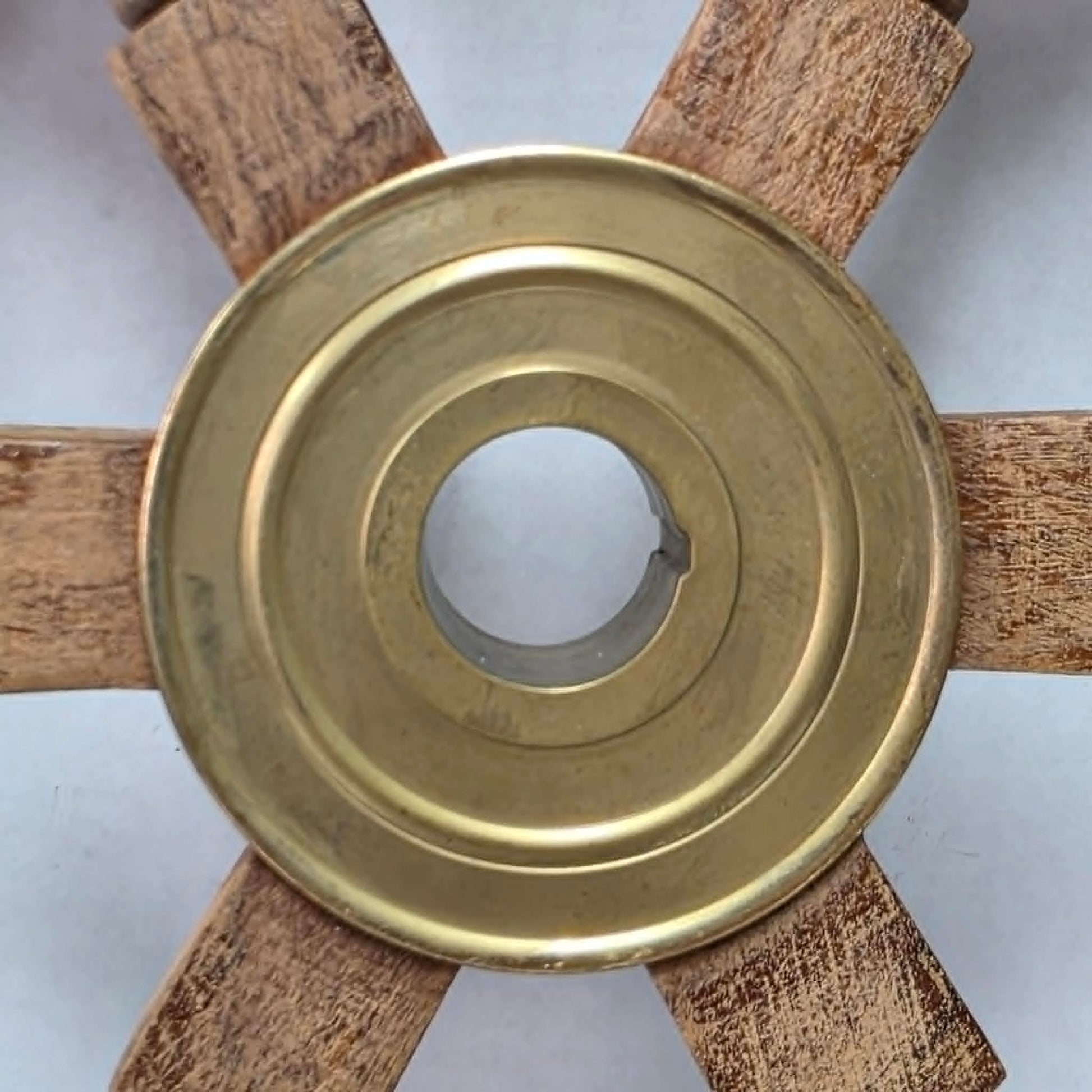 Authentic vintage wood and brass ship's wheel with beautiful original maritime patina.