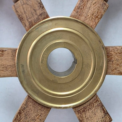 Authentic vintage wood and brass ship's wheel with beautiful original maritime patina.