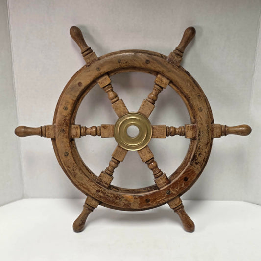 Authentic vintage wood and brass ship's wheel with beautiful original maritime patina.