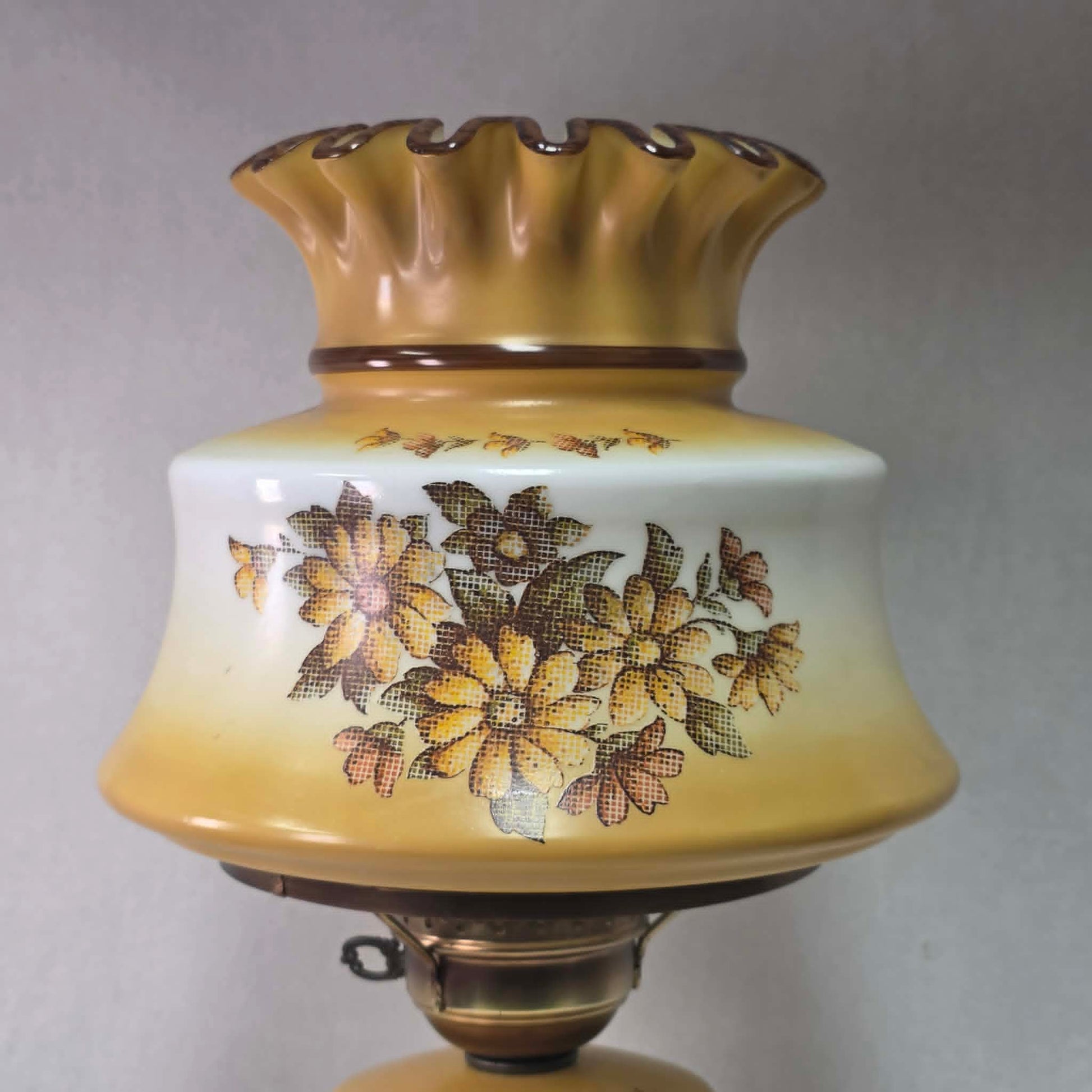 Vintage harvest gold hurricane lamp with needlepoint floral shade and font featuring tri-light operation.