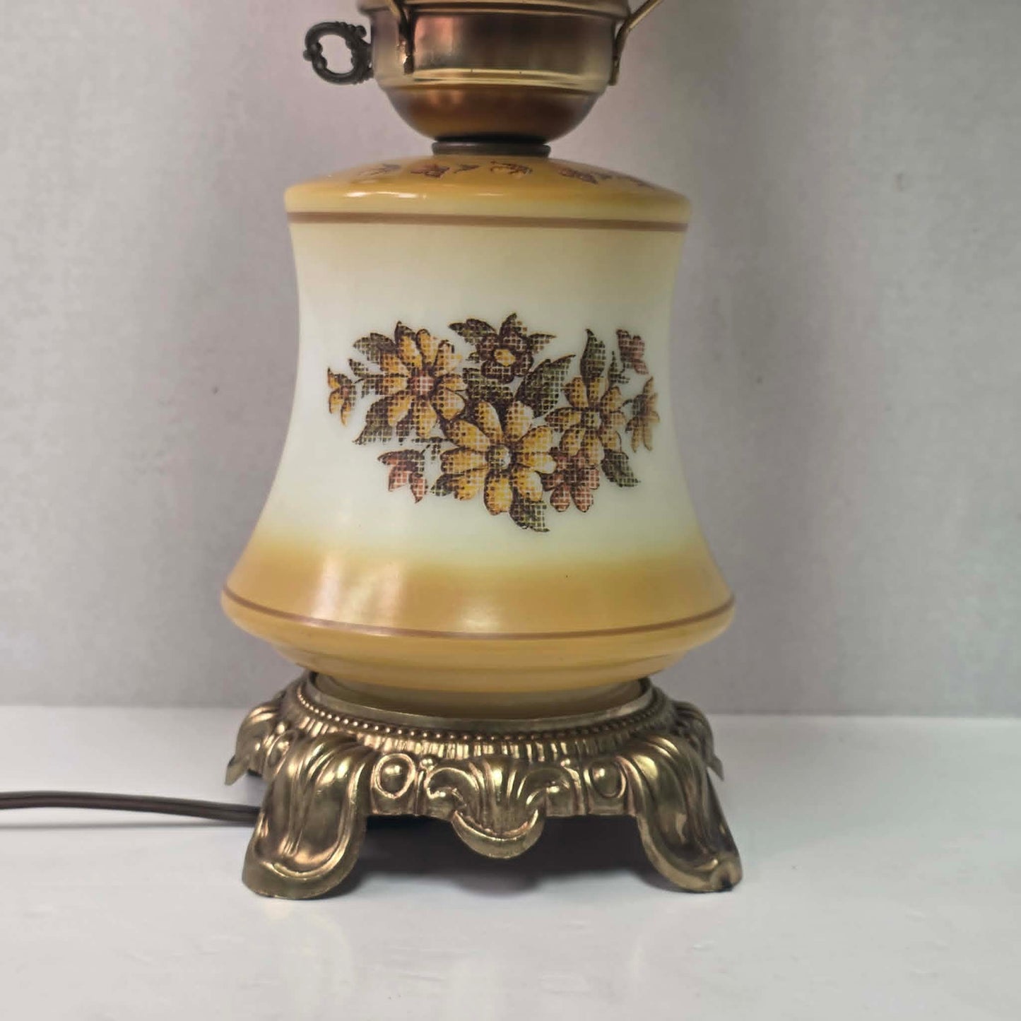 Vintage harvest gold hurricane lamp with needlepoint floral shade and font featuring tri-light operation.