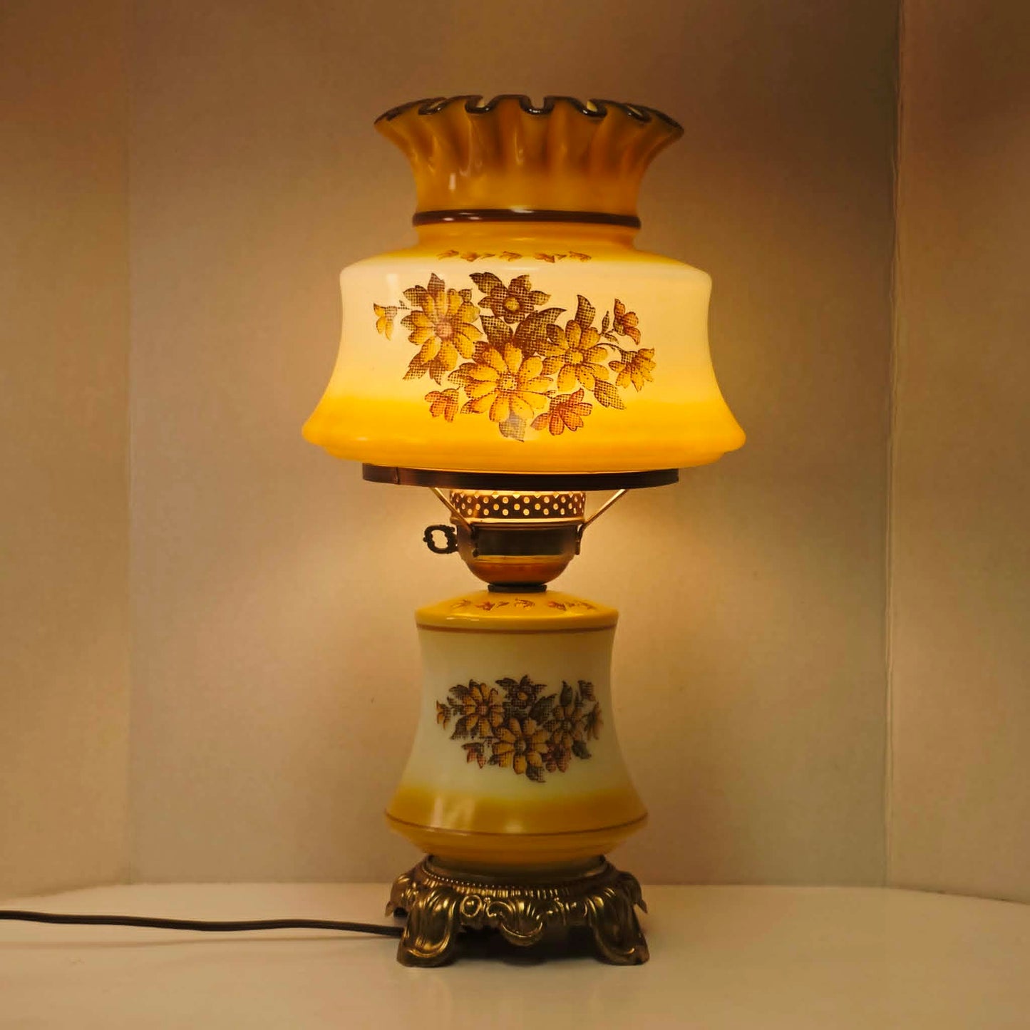 Vintage harvest gold hurricane lamp with needlepoint floral shade and font featuring tri-light operation.