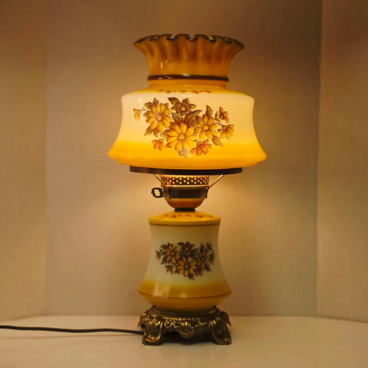 Vintage harvest gold hurricane lamp with needlepoint floral shade and font featuring tri-light operation.
