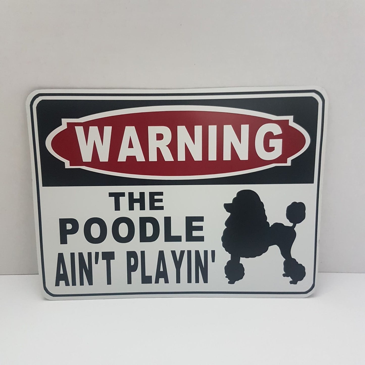 warning the poodle ain't playin' funny sign