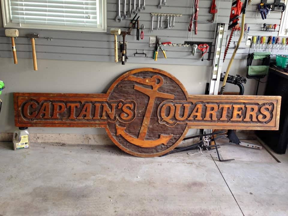 carved wooden sign captains quarters