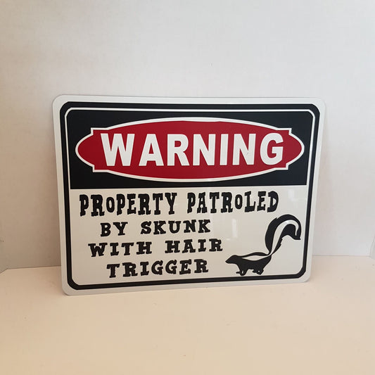 beware of skunk sign  warning property protected skunk with hair trigger