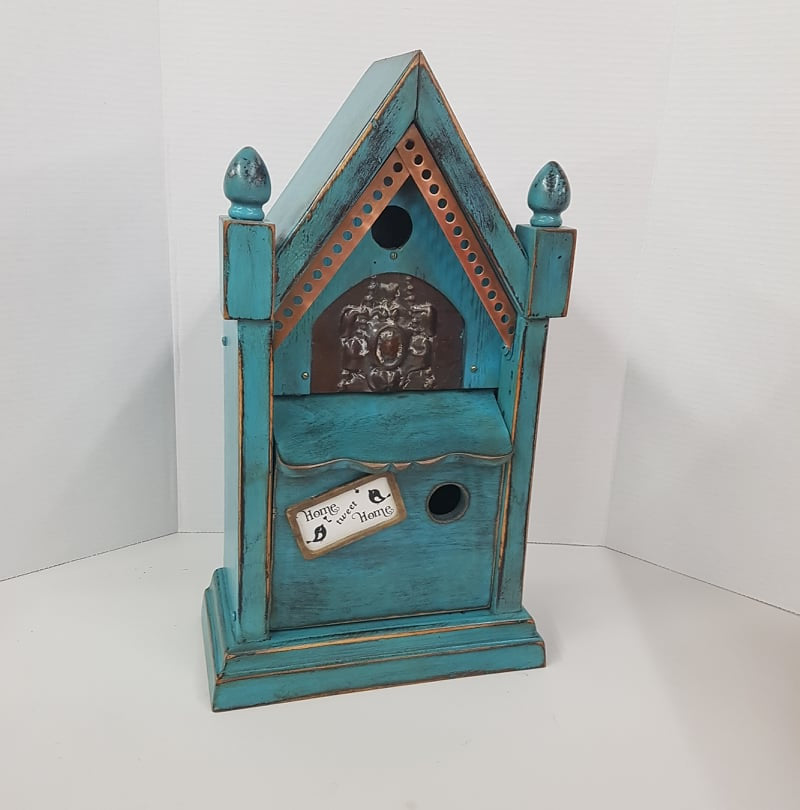 rustic birdhouse hand built from an antique steeple clock case
