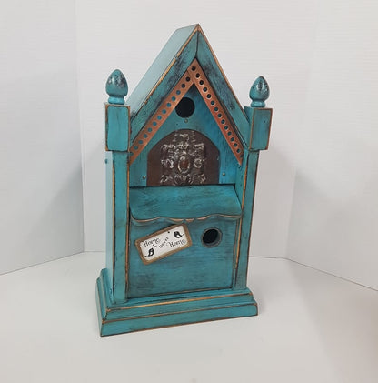 rustic birdhouse hand built from an antique steeple clock case